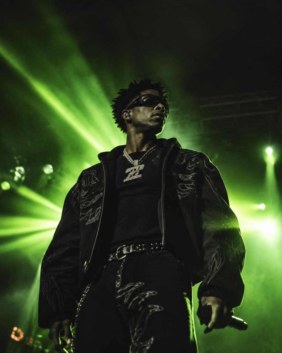 Artist performing live under stage lights